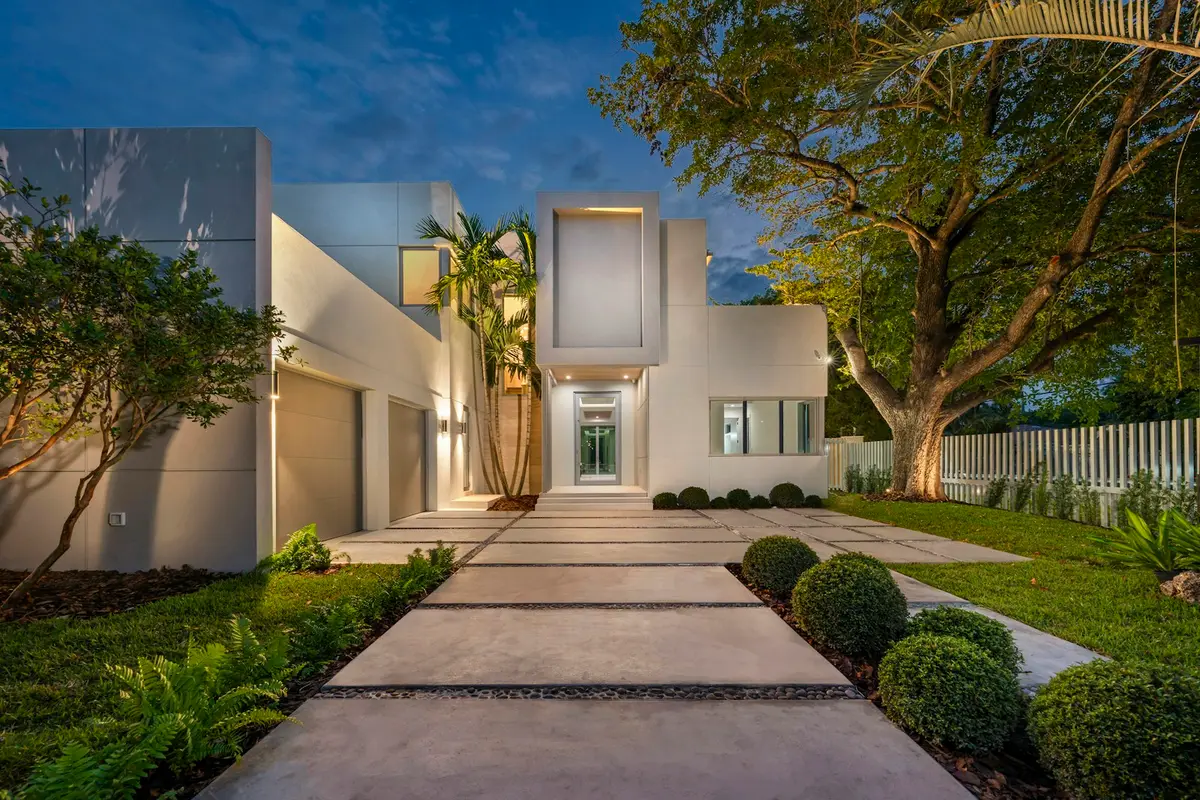 Front path of large concrete pads leading to a modern white house