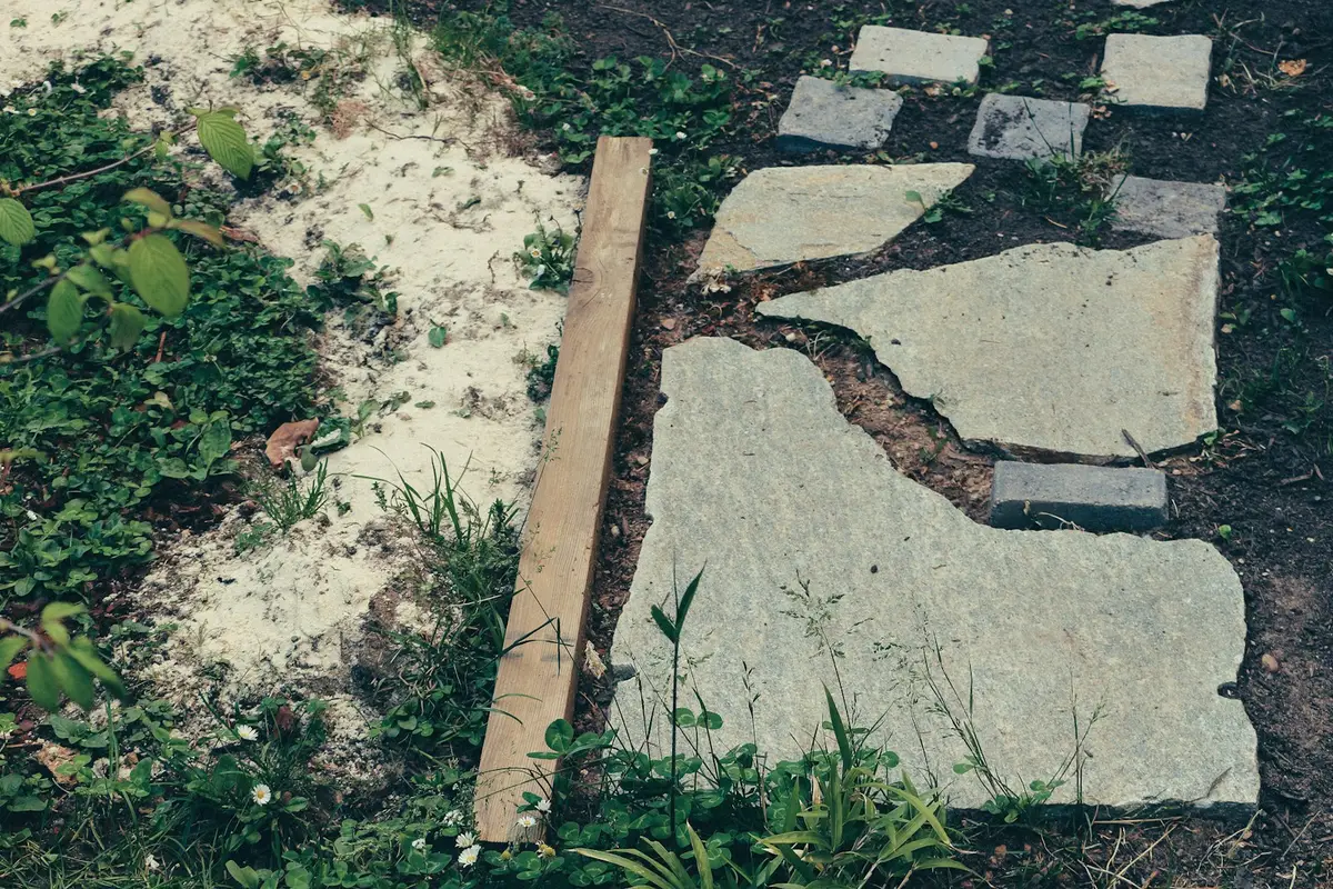 Flat stepping stones set into a garden bed